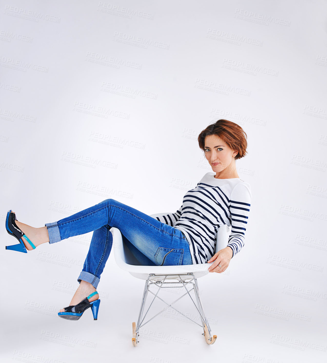 Buy stock photo Fashion, chair and portrait of woman in studio for sweater style, trendy clothing and jeans with white background. Smile, relax and person for happiness, confidence or comfortable outfit on mockup