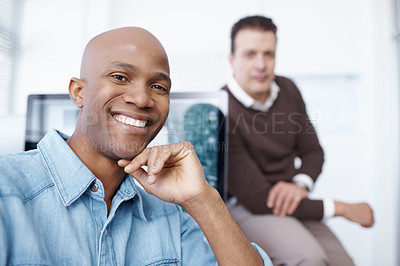 Buy stock photo Portrait of two coworkers sitting in the office together