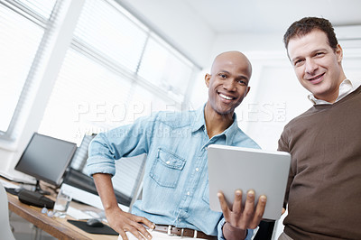 Buy stock photo Portrait of two businessmen sharing a digital tablet in the office