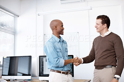 Buy stock photo Two businessmen shaking hands in the office