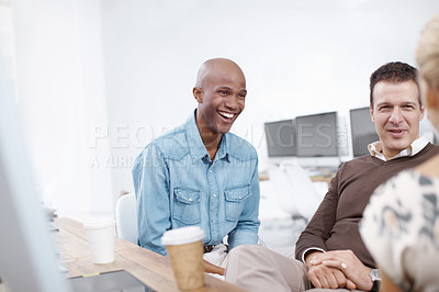 Buy stock photo Three coworkers talking in an informal meeting together