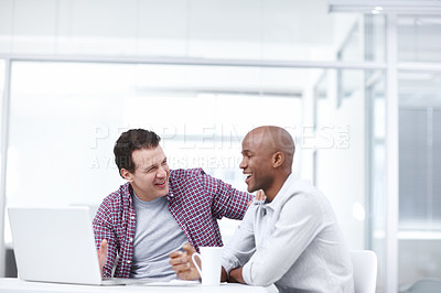 Buy stock photo A businessman encouraging his junior colleague as they work together on a project