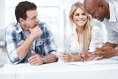 Buy stock photo Three design professionals having a meeting