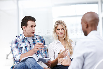 Buy stock photo A group of businesspeople in a meeting thinking of ideas and making notes