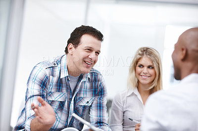 Buy stock photo A group of professionals having a work discussion