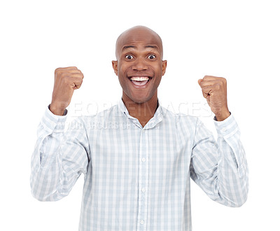 Buy stock photo Studio portrait of an excited young man raising his fists up in the air and smiling broadly at the camera