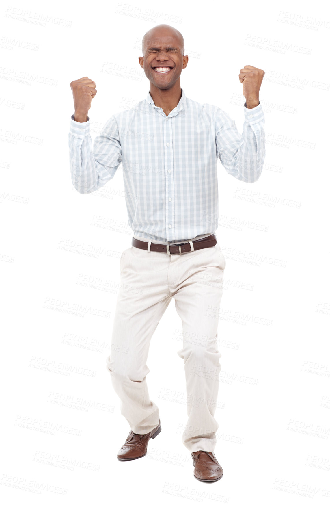 Buy stock photo Full length studio shot of an excited young man with his eyes closed raising his fists up in the air and smiling broadly at the camera