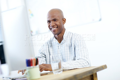 Buy stock photo Shot of a young african american designer at work on a desktop computer in the office