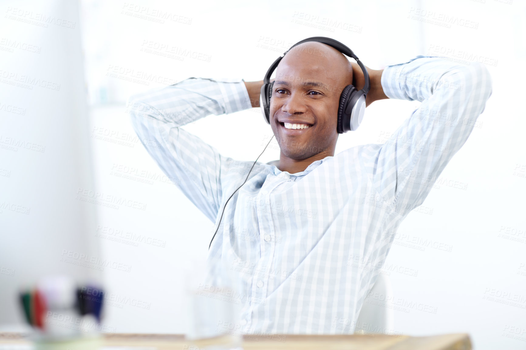 Buy stock photo Business, black man and relax with headphones by computer for watching online video or listening to music. Designer, person or resting by desk with streaming subscription, work break or finished task