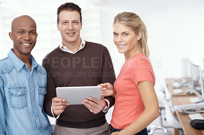 Buy stock photo Portrait of three businesspeople sharing a digital tablet in the office