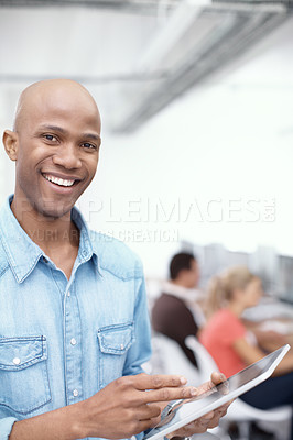 Buy stock photo Portrait of a young businessman using a digital tablet in the office