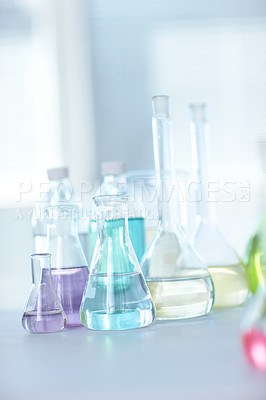 Buy stock photo Vials filled with colourful liquid on a table in a laboratory