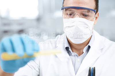 Buy stock photo Closeup of a chemist in the process of mixing chemicals