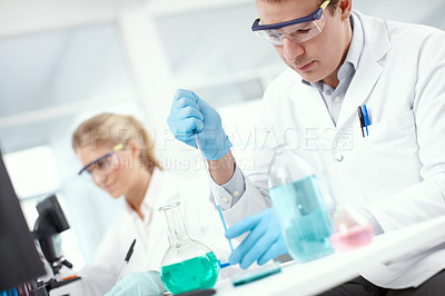 Buy stock photo Two researchers busy working in the laboratory