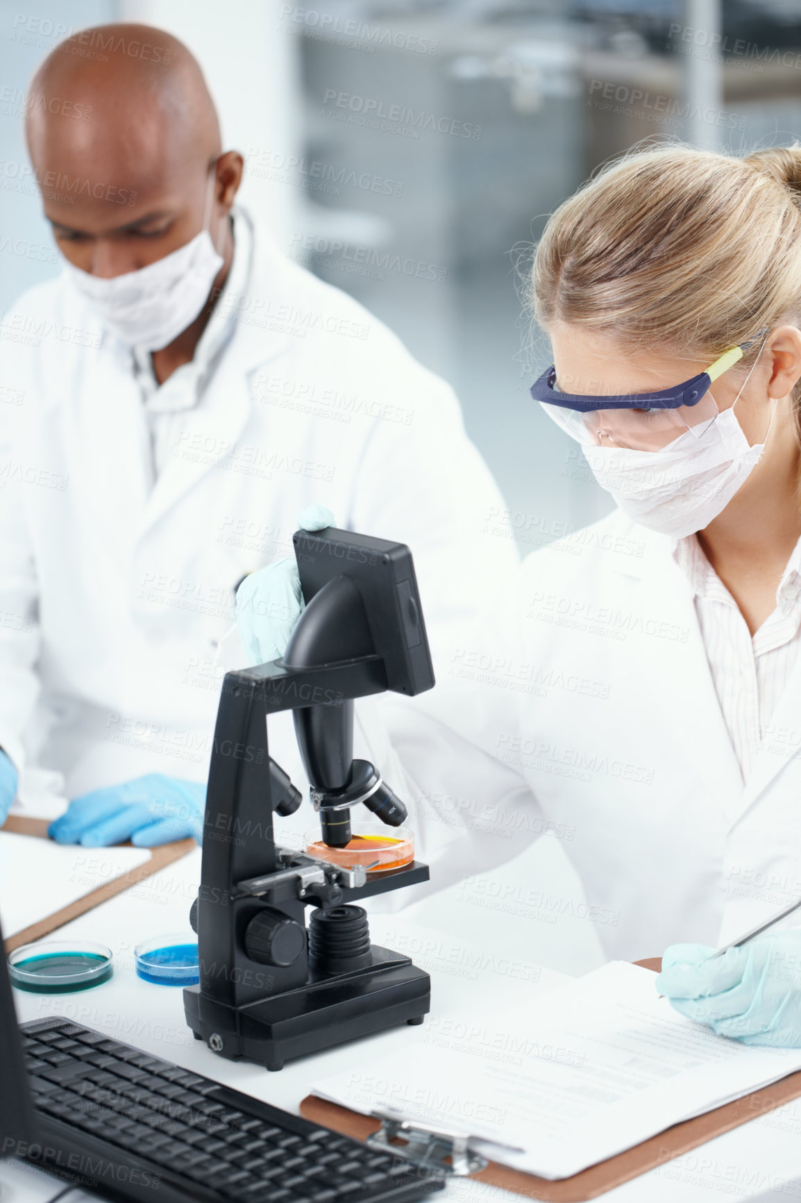 Buy stock photo Notes, man and woman in laboratory with microscope, mask and technology in science research. Evaluation, scientist and medical team with biotech data, pharmaceutical innovation or vaccine development
