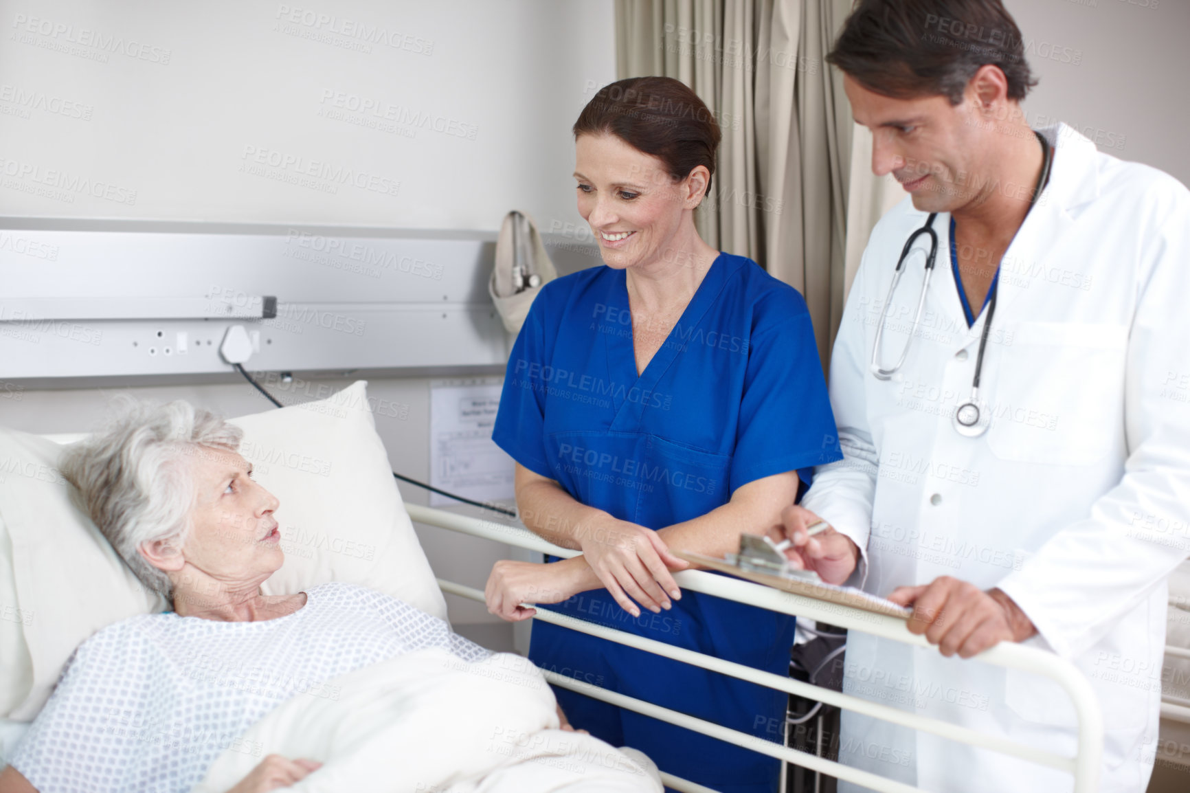 Buy stock photo Medical, team and senior patient in hospital bed for healthcare results, surgery information and checkup notes. Elderly woman, nurse and doctor with clipboard in clinic for health support or recovery