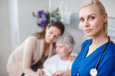 Buy stock photo Portrait of a young nurse with a senior patient and her daughter in the background