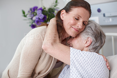 Buy stock photo An affectionate daughter embracing her sick mother in the hospital