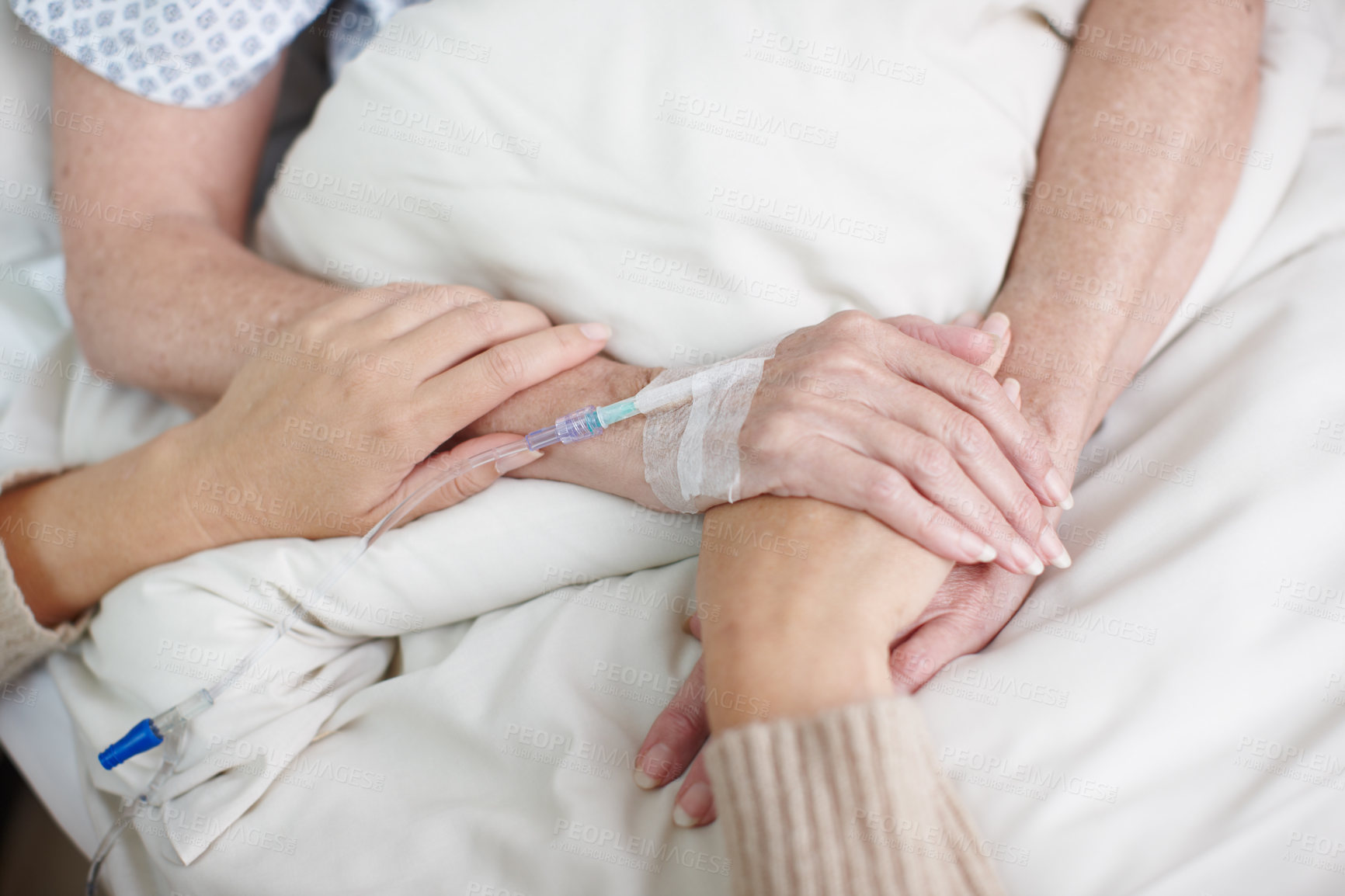 Buy stock photo Cropped image of an affectionate daughter's hand being held by her mother in the hospital