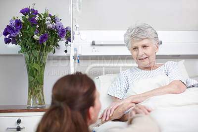 Buy stock photo An affectionate daughter comforting her ill mother in the hospital
