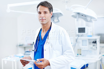 Buy stock photo A confident male doctor holding a chart in the hospital