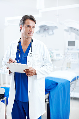 Buy stock photo A confident male doctor marking a chart in the hospital
