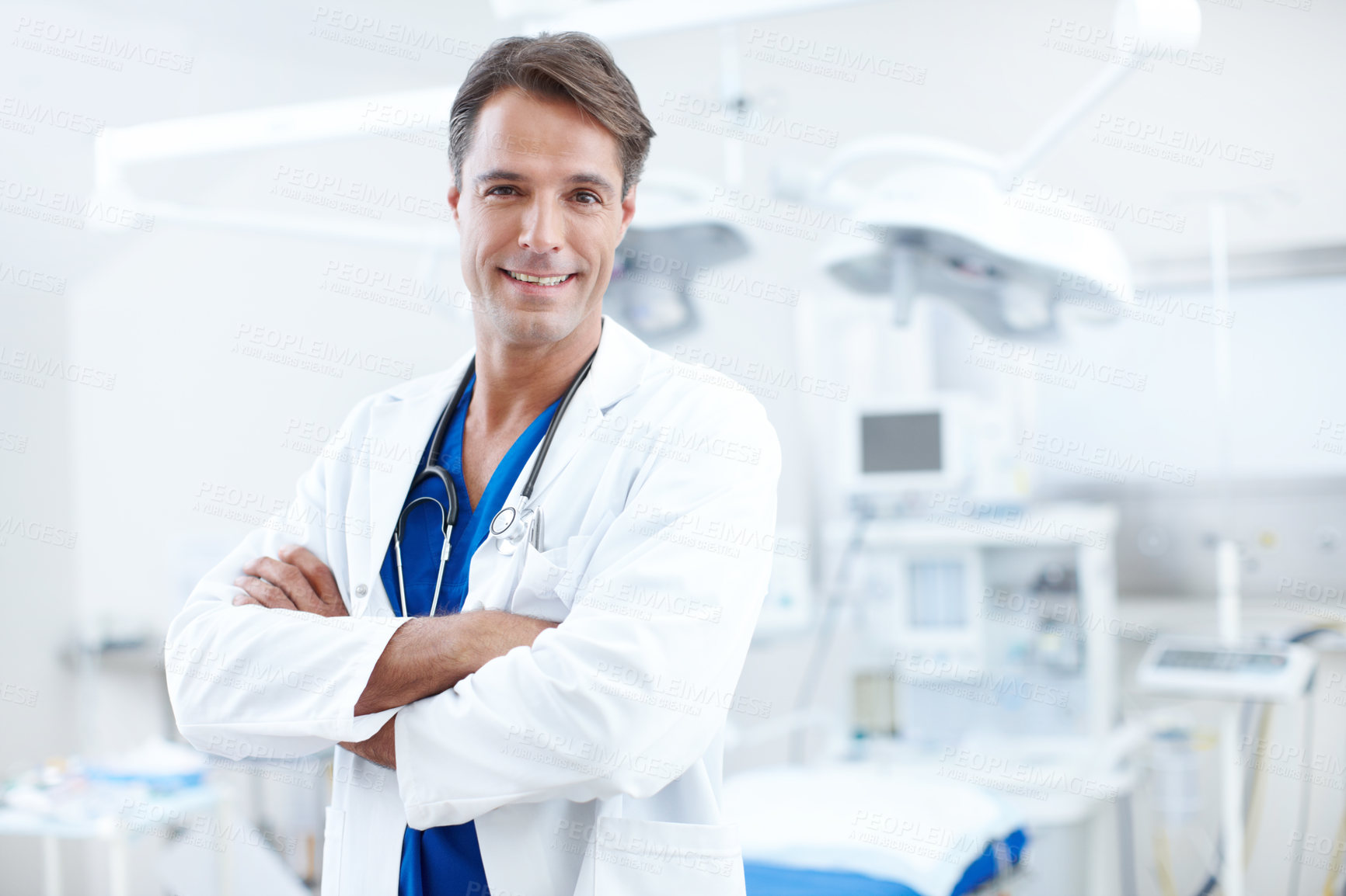 Buy stock photo Smile, doctor and portrait of man with confidence, trust and expert consultant in health insurance. Hospital, physician and medical professional in operating room with care, arms crossed and pride