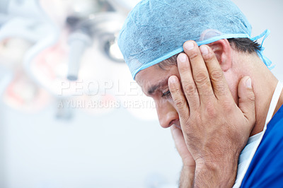 Buy stock photo Close-up profile of a doctor with his hands raised up to his face