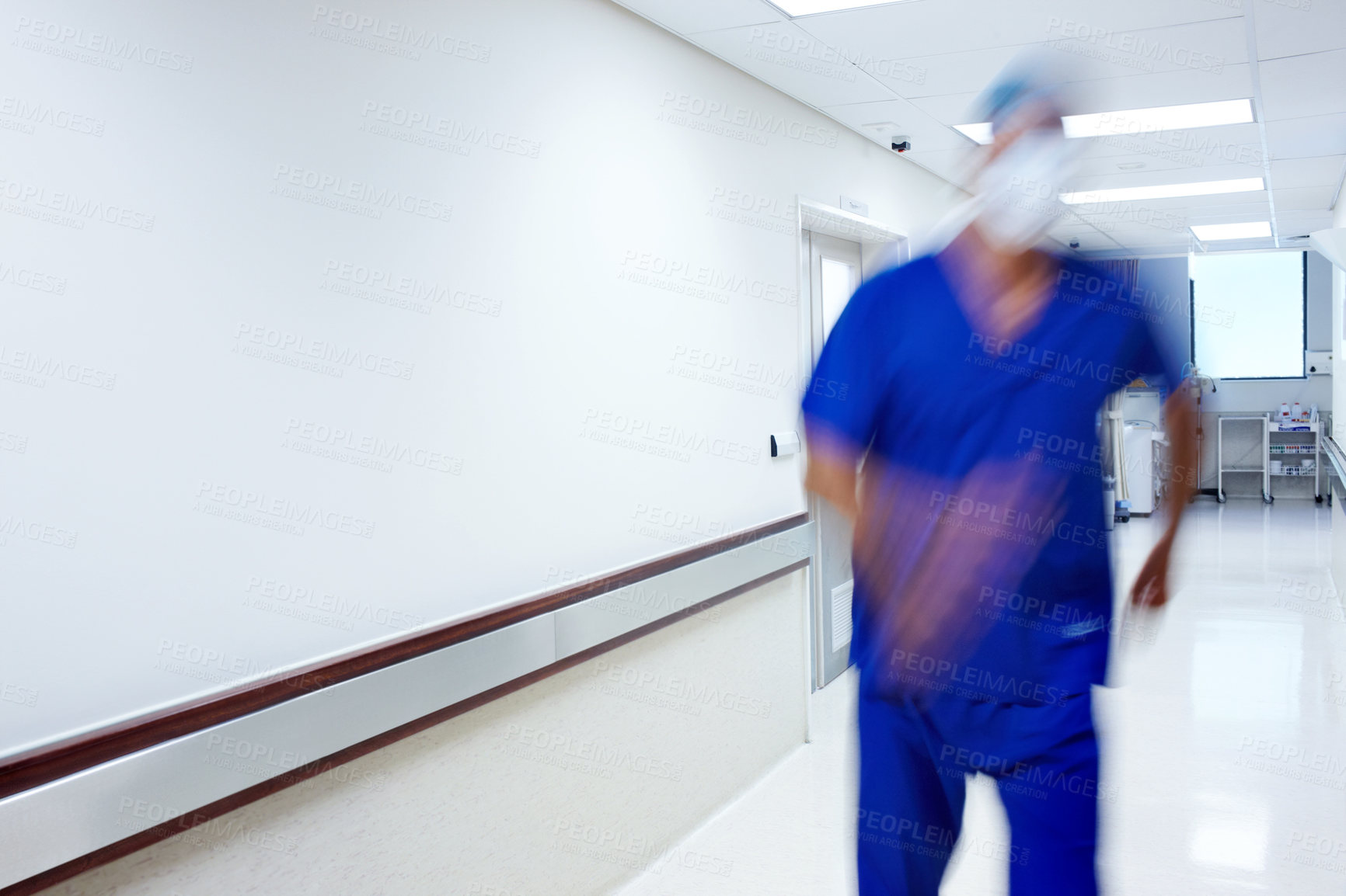 Buy stock photo A doctor rushing in the hallway of a hospital