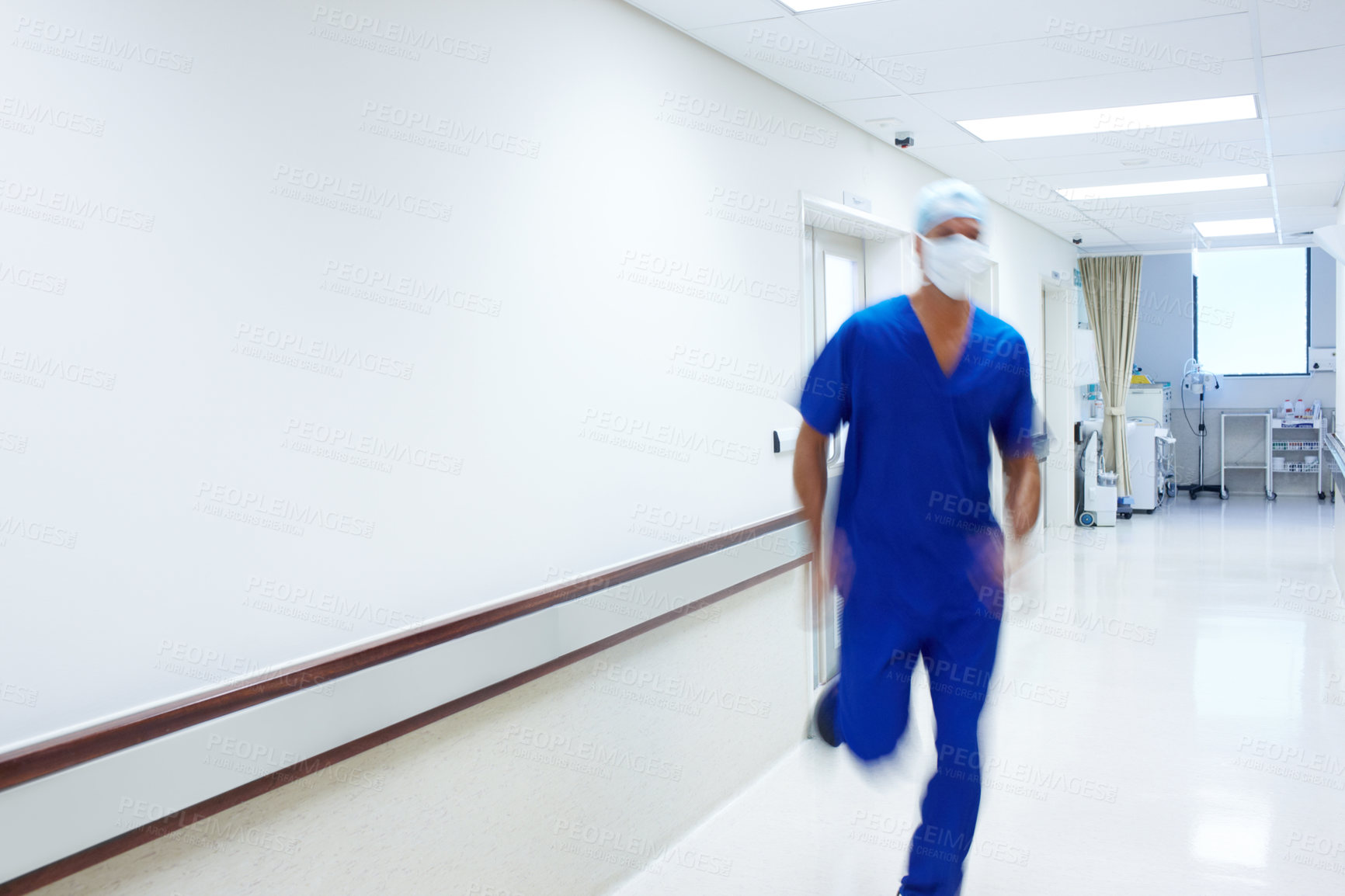 Buy stock photo A doctor rushing in the passage of a hospital