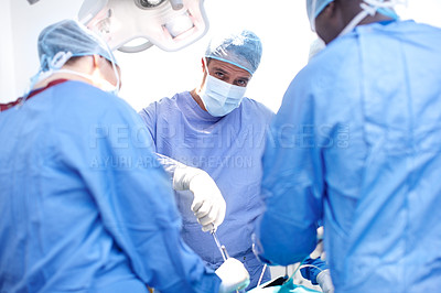 Buy stock photo Portrait of a male surgeon performing surgery on a patient in an operating theatre