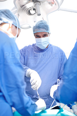 Buy stock photo Surgery, teamwork and portrait of doctor in operating room for healthcare with emergency medical treatment. Confidence, people and surgeon in theater together with equipment, support or hospital care