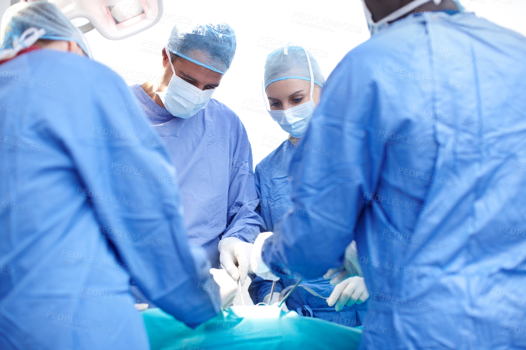 Buy stock photo Surgery, teamwork and doctors in operating room with ppe, healthcare and emergency medical treatment at hospital. People, surgeon and nurses in theater together with equipment, support or trauma care