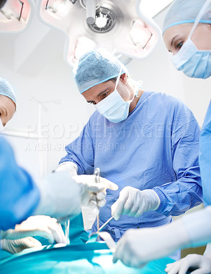 Buy stock photo Side profile of a male doctor performing surgery 