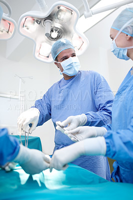 Buy stock photo Surgery, team and doctors in operating room with medical tools, healthcare and expert treatment at hospital. Men, women and surgeon in theater together with ppe equipment, support and emergency care