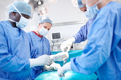 Buy stock photo Surgeon, group and theater with procedure at hospital with equipment, solution or help for healthcare services. People, teamwork and circle with tools for emergency operation with scrubs at clinic