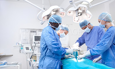 Buy stock photo Meidcal surgeons performing surgery in an operating theatre together - Copyspace