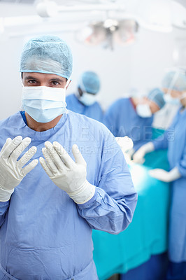 Buy stock photo Doctors, surgery and teamwork with man in hospital for healthcare, operating room and emergency. Medical, organ transplant and portrait with person in clinic for sterile, procedure and face mask