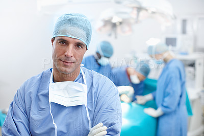Buy stock photo Portrait of a serious surgeon standing in an operating theatre