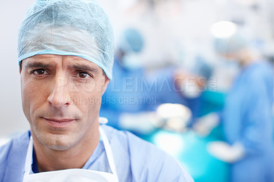 Buy stock photo Medical, surgery and doctors with man in theatre for teamwork, operating room and emergency. Cardiology, organ transplant and portrait with person in hospital for clinic, healthcare and pride