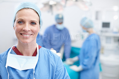 Buy stock photo Portrait of a mature female doctor smiling in an operating room 