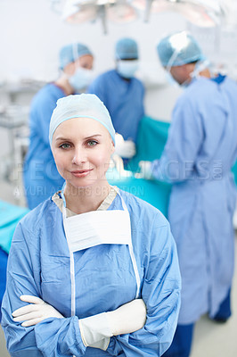 Buy stock photo Woman, doctor and portrait in hospital for theater, medical surgery and procedure for staff. Healthcare, team leader and surgeon with smile for operating room, arms crossed and ppe uniform for safety