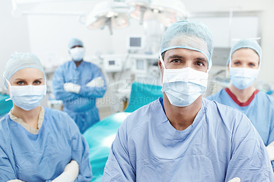 Buy stock photo Portrait of a medical team of surgeons standing together in an operating theatre before surgery