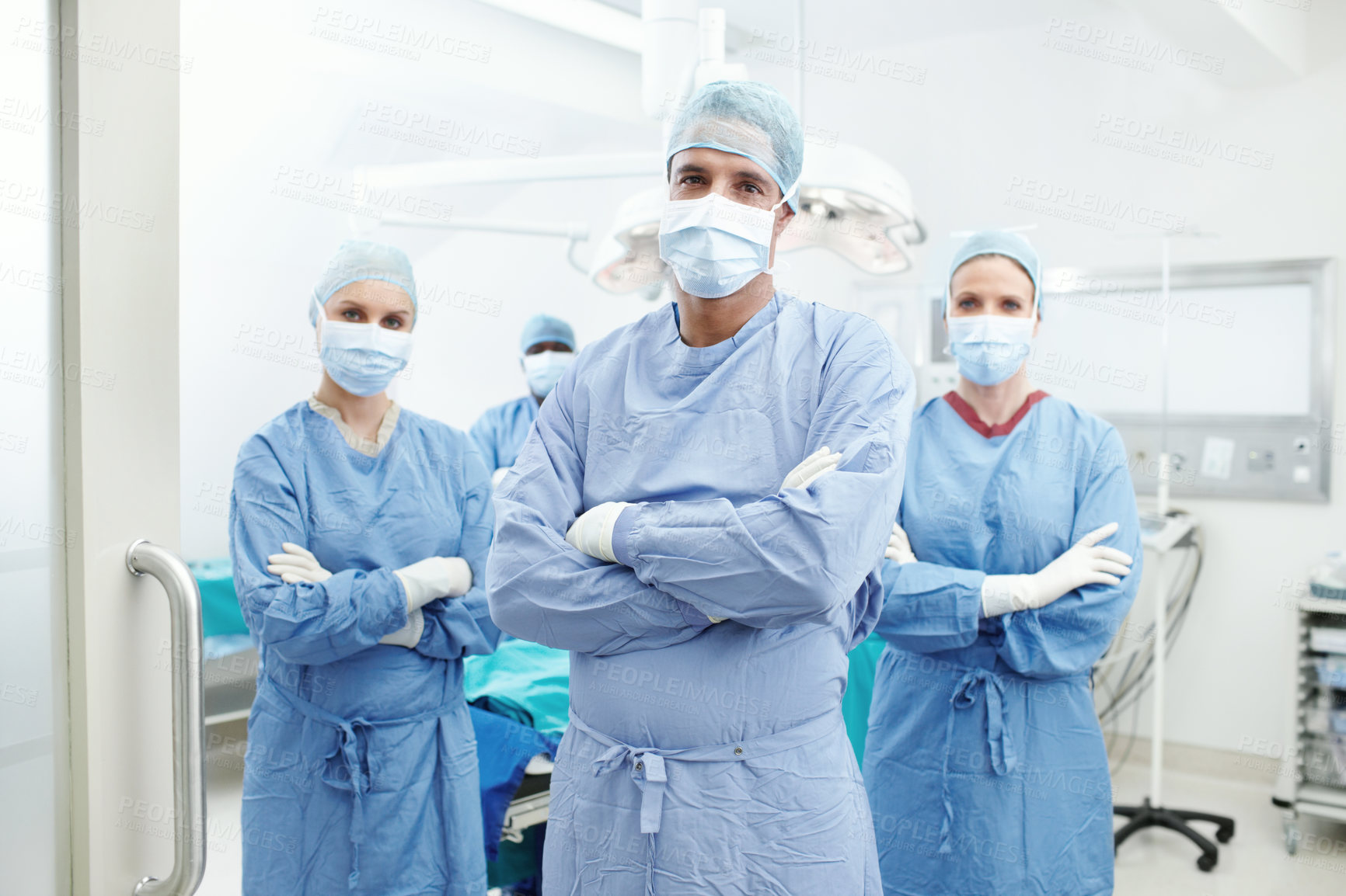 Buy stock photo Theater, doctors and portrait with face mask in hospital, medical surgery or procedure with pride. Team, surgeons and man leader with arms crossed for operating room, clinic or ppe uniform for safety