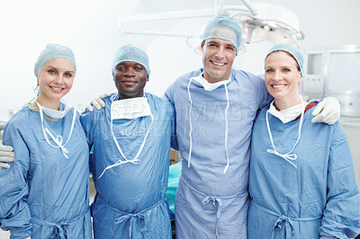 Buy stock photo A happy team of medical surgeons and doctors embarcing one another in an operating theatre - Teamwork