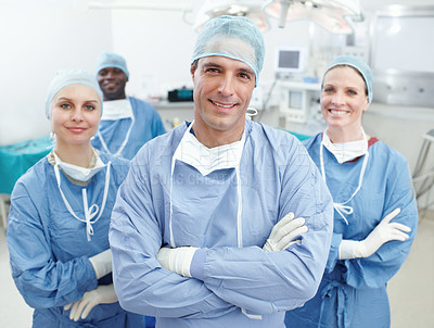 Buy stock photo Happy, doctors and teamwork in portrait for theater, medical surgery and procedure with confidence. Hospital, surgeons and man leader with arms crossed for operating room, clinic and ppe for safety