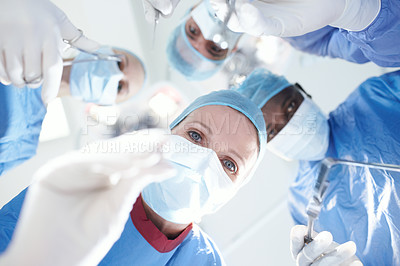 Buy stock photo Patient's view of medical surgeons and doctors operating