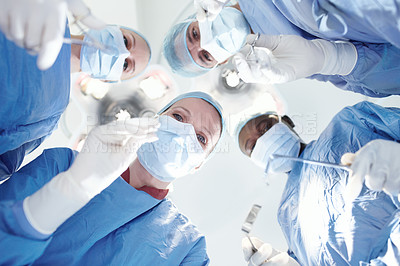 Buy stock photo Low angle, people or surgeons in operation for surgery, emergency accident or healthcare in hospital theatre. Mask, tools or doctors in surgical scrubs in operating room for teamwork, support or help