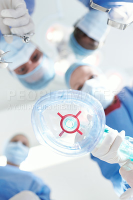 Buy stock photo Patient's view of medical surgeons and doctors putting them under a general anaesthetic