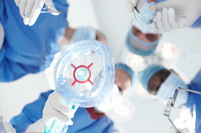 Buy stock photo Patient's view of medical surgeons and doctors putting them under a general anaesthetic